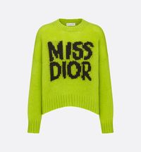 The sweater features the black Miss Dior Graffiti motif, a nod to the 1967 debut ready-to-wear collection and a manifesto to Maria Grazia Chiuri's signature celebration of feminism. Crafted in a cobalt green cashmere and silk knit, it is distinguished by its oversized fit with a ribbed hem and cuffs. The round-neck sweater can be worn with casual outfits in any season and will coordinate well with other Miss Dior Graffiti creations..