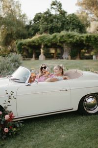 Guests Posing for Photo in Vintage Car