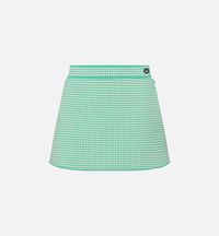 Part of the Dioriviera capsule, the miniskirt showcases the House's iconic houndstooth motif. Crafted in white and aquamarina technical knit, it features a flared silhouette. The refined miniskirt will pair with other Dioriviera creations to complete the look.. 38