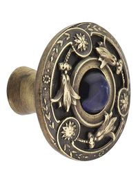 Inspired by Victorian era broaches and pins, this lovely cabinet knob features a design of delicate lilies encircling a single blue sodalite. Intricate and refined, it is the finishing touch to your fine furniture and cabinetry. Precision cast in pewter for exceptional detail, then plated and hand-finished to highlight the pattern. Handcrafted in the USA.