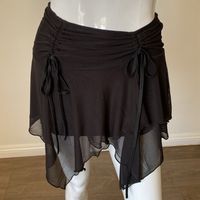 Layered Mesh Mini Skirt With An Asymmetrical Handkerchief Hem. Ruches On Either Side With Adjustable Ties. Sold Out On Dolls Kill.