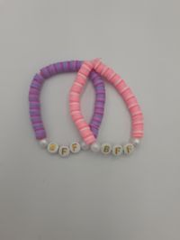 Pink and purple bff matching clay bead bracelets. Made to fit most wrists but has elastic so it will stretch.