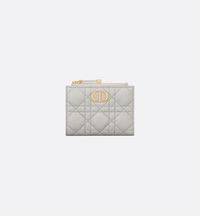 The Dior Caro Dahlia wallet displays the iconic Cannage topstitching in a contemporary variation. Crafted in cloud gray supple calfskin, it has a CD signature on the front. The chic and spacious companion can be coordinated with other bags from the same line..