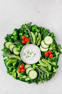 For the Christmas holiday, this crudite platter wreath offers guests a festive healthy beautiful platter filled with vegetables and a homemade ranch dip! | Vegetable Tray | Crudite | Appetizers | Party Food | Holiday Parties | #cruditeplatter #crudite #veggietray #vegetables #wreath #christmas #feelgoodfoodie