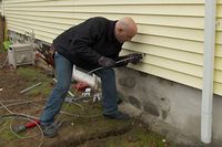 Electrician Scott Caron shows a homeowner how to bring power to a detached garage.