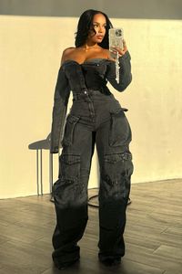 Off shoulder long sleeve denim jumpsuit featuring baggy leg details with cargo pockets Front button up closure We recommend wearing pasties, a strapless bra, or no bra with this garment Runs true to size 100 % Cotton Aaliyah is in size S Height: 5'0" Bust: 34" Waist: 24" Hips: 44"