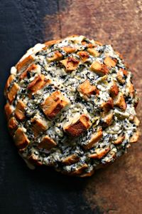 Spinach Artichoke Cheesy Bread. This recipe is chock full of flavor yet remarkably easy to make. The bread is stuffed with spinach artichoke dip and cheese. You need to make this bread immediately. #appetizer #pullapartbread