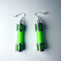 Glow in the dark earrings have hypoallergenic hooks; earring backs included. Each pair is printed using PLA plastic. Must be charged under a light source to glow. Measurements; length includes hook. Add these custom earrings to your '80s flair! 2.85" x .5" x .5"