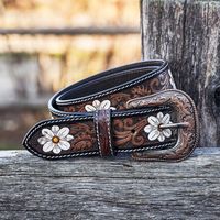 Add a touch of femininity to your western style with our White Flower Hand Tooled Leather Western Belt. Made from genuine leather and featuring intricate tooled leather designs, this waist belt is a stunning accessory for any outfit. Our custom leather belt is available in a range of sizes for both men and women, ensuring the perfect fit. The white flower accents in the tooled leather designs add a delicate touch to this classic western belt. Whether you're looking for a leather belt for women or a custom western belt, our tooled leather belt is a stylish and functional choice. It's not just a fashion accessory, but also a practical piece of clothing that will hold up your pants or skirt. Materials: tooled leather Color: Brown, White, and Silver  Dimensions: Width: 1.5 in x Length: Vary