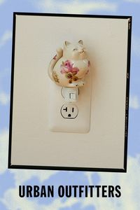 Light up your space with a purr-fect glow when you display this porcelain nightlight. Features a smiling cat silhouette with floral motifs painted allover. Plugs in to power on. Features Whimsical nightlight Crafted from porcelain with a cat silhouette Finished with whimsical motifs painted allover Plug in Content + Care Porcelain Wipe clean Imported Made in compliance with US electrical standards. To use this item outside of the US, pair with an outlet adapter and voltage converter made specifically for use in your location. Size Dimensions: 3" l x 3" w x 4" h Weight: 0.5 lbs | Cat Nightlight in Assorted at Urban Outfitters