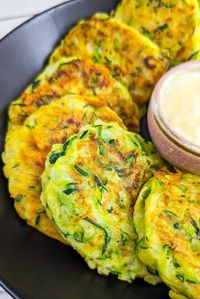 Enjoy simple and flavorful 4-Ingredient Zucchini Fritters! Made with shredded zucchini, flour, egg, and onion. Versatile and delightful as a snack or appetizer. Get creative with herbs and spices!