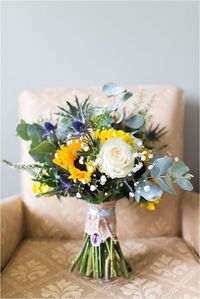 sunflower and white organic wedding bouquets with blue thistles