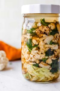 My easy yet flavorful fermented cauliflower recipe requires only a few simple ingredients: cauliflower, garlic, poblano pepper, salt, curry powder, water, and a large cabbage leaf. I fire-roasted the cauliflower, poblano, and garlic for this recipe to enhance the flavor. #cauliflower #fermented