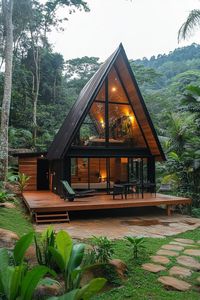 Modern tiny log cabin with A frame facade in tropical mountain forest. Check out these stunning houses nestled in the serene and rugged beauty of mountain woods. Get inspired by nature!