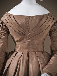 A pleated skirt and bodice and lovely shirred sleeves on a mid-1840s dress. Day dress ca. 1845 From LACMA.