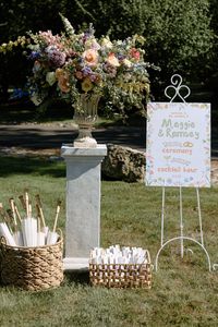 Bridgerton Inspired Welcome Sign & Umbrellas #WeddingChicks #floralwedding #gardenwedding #bridgertonwedding #pastelwedding