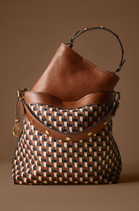 This LiteHide™ leather bucket shoulder bag features 1 center zipper compartment and 1 detachable shoulder strap.