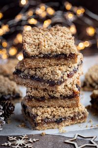 Vegan mincemeat crumble bars - mince pies in a quick and easy to make traybake form! A crunchy, oaty biscuit base and crumble topping are filled with sweet, fruity mincemeat. It can all be made in one bowl and is much easier than rolling out pastry!