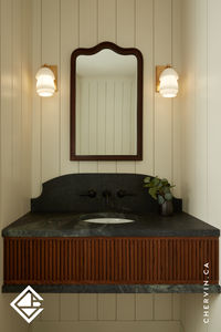 Simplicity meets sophistication in this exquisite floating vanity. The reeded red oak finished in a rich-warm stain, perfectly complements the striking black countertop, creating a stunning focal point for this powder room. 🤎🖤...#BathroomVanity #PowderRoom #BathroomVanityIdeas #ReededVanity