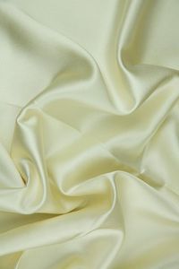 Ivory Silk Crepe Back Satin Fabric is a lighter medium weight, shiny fabric with a similar look and drape to charmeuse. Distinguished by its luxurious design, this high-quality fabric is perfect for eveningwear, bridal/wedding, and lingerie. The face side of this fabric features a glossy satin finish while the back has a traditional pebbly crepe texture. Our unique and distinctive fabric is available in a wide selection of colors. The fabric is sold by the Yard, and measures 44 inches in width.