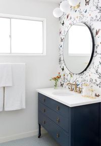 The clean simple colors in this bathroom goes so well with the brightly colored yet clean looking wallpaper. I'm totally digging it!