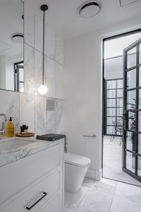 Perfectly placed in this powder room referencing the timeless steel doors