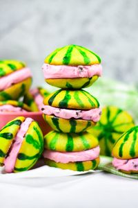 A recipe for miniature watermelon whoopie pies filled with pink chocolate chip watermelon buttercream. A perfect treat for picnics and summer gatherings!