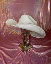 PLEASE HEAD OVER TO OUR NEW WEBSITE TO ORDER - SHOPRHINESTONECOWGIRL.COM WE WILL BE CLOSING OUR ETSY SHOP BY THE END OF THE YEAR! THANK YOU! The white + crystal combination is our #1 seller!! Perfect for any concert, Nashville trip, bacherlotte party or just because! This hat will match every outfit you have and is truly a show stopper!  This hat features -white straw hat (one size fits all - stretchy band on the inside) -crystal rhinestones -you select whether you want just the underneath brim