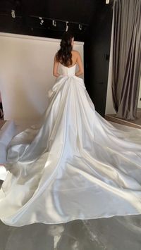 Strapless sweetheart neckline satin minimalist long train wedding dress with bow on the back Summer wedding dress ideas Big bow wedding gown Wedding dress inspo