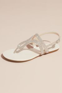 Add sparkle to a casual look with these shimmering flat sandals with multi-size crystals strewn atop the looping, glittery straps. Synthetic Adjustable buckle Imported