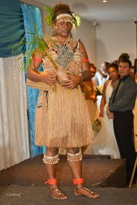 1995. Traditional Solomon Islands Bride Price. Veronica Fatnowna wore a similar Bride Price garment. This garment is made of shell money and natural tree fibres. A traditional Solomon Islander dress, the shells are assoicated with the Bride Price. It is common for these dresses to be accompanied by newly green coconut seedling. Model by Dianna