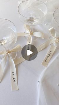 CREO on Instagram: "I’m in loveeee… personalised ribbons 🤍🥂   Everyone is loving bows and ribbons this season, and I adore this trend for event decor. So I am now offering these gorgeous satin ribbons, with heat pressed vinyl names.   The ribbons can be used in many ways; - Place settings / alternatives for place cards - Bridal party gifts - Drinks tags - Wedding bouquet accessories  - Gift wrapping - Branding  Shop this particular size and style online now, or contact me to request any custom size and colour scheme 🎀 . . . #weddingstationery #bowseason #personalisedribbon"