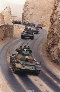 Type 59 tanks leading motorized convoy during exercise in western China, circa 1990s