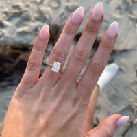 Emerald Cut Demi Diamond Engagement Ring (1/3 ct. tw.) - 18K Yellow Gold. This elegant engagement ring features a glittering hidden halo of diamonds that wraps around the center gem. A petite band complements the gallery for an elegant, chic look (1/3 total carat weight).