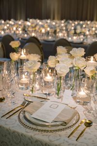 Romantic White Roses and Gold Accents Illuminated by Dancing Candlelight| wedding, wedding inspo, wedding decor, wedding reception decor, wedding tablescapes, wedding table decor, wedding table ideas, wedding table centerpieces, wedding linens, linens for wedding, wedding tablecloths, linens for events, luxury linens, elegant linens, couture linens, patterned linens, elegant wedding decor, 2024 wedding, table decorations, table ideas #weddingreception #tabledecor #linens