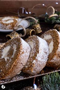 This moist gingerbread cake roll recipe has the signature spiced gingerbread flavor with the addition of a rich and tangy eggnog cream cheese filling. | gingerbread swiss roll | gingerbread yule log | christmas dessert recipe | holiday baking