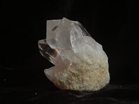 Clear Arkansas cluster that was self mined. There is some damage to the main point face. It is a  channeling main point with 7 sides and the 3 sided face directly behind it. It sits perfectly on a flat matrix. The weight is 63g and the size is approximately 1 3/4 X 1 1/4 X 1 3/8