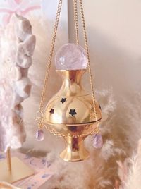 Immerse yourself in the mystique of this ethereal creation. Meticulously crafted with the divine touch of Amethyst crystal frequencies that grace this magical incense burner, radiating energies of protection, manifestation, and unwavering focus. Three high quality faceted Amethyst crystal beads and one Amethyst crystal