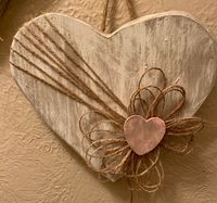 "Two Farmhouse decorative hearts, Wooden and whitewashed. Beautiful for Valentine's Day or Home decor that can be used all year.. These are not cookie cutter hearts, they are primitively cut, stained, whitewash and sanded. This set of hearts can be hung on a wall, on a door handle or leaned against candle sticks. Your imagination is your only limit. The are unique in cut and color. Each wood heart is decorated with burlap twine, a burlap twine flower with a heart centerpiece that has been pink w