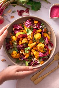 Looking for a healthy, yet satisfying & delicious lunch idea? This roasted cauliflower and beet bowl by nutritionist Sarah Cobacho is high in protein & iron, combining crispy vegetables, beans, grains & a tangy pink beet dressing for a yummy nutritiously balanced meal. Enjoy it as a wholesome & comforting lunch or weeknight dinner that can also be meal prepped. #Vegetarian #MealPrep #GlutenFree #EasyVeganRecipes #HealthyRecipes #VeggieBowl #HighProtein #PlantProtein #PlantBased #Vegan 💗🌿