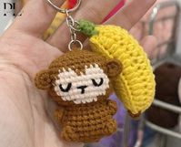 Crochet Monkey With Banana Keychain, Amigurumi Monkey, Crochet Baby Monkey Plush Toy Keychain, Monkey Stuffed Animal, Monkey Cute Gifts CUTE MONKEY WITH BANANA KEYCHAIN Materials: This lovely animal amigurumi is crocheted with cotton yarn, soft for skin. Cute mini monkey keychain is meticulously handcrafted by hand This cute baby monkey and banana amigurumi measures about 6cm in length CUTE GIFT FOR YOUR LOVERS If you are looking for a meaningful handmade gift, this little monkey keyring will be great choice to you.  It will be lovely gift for your girlfriend, your family, your friend, your besties or someone loved as birthday gift, anniversary gift,... Product may slightly vary due to lighting sources or monitor settings. Hope you can understand! If you have any questions or requests, ple