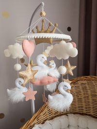 Swan baby mobile for girl Princess pink gold nursery decor Felt crib mobile Baby shower gift Princess Swan Stars Heart baby mobile The baby mobile is handmade from felt and includes Swans, crown, hearts, clouds and stars . It is a great way to enrich your babys room, and a beautiful gift for your baby or baby shower. The baby mobile can be made with custom colors. A beautiful and minimalist mobile in a crib that will complement your baby's room. The mobile is easy to hang and can be adjusted acc