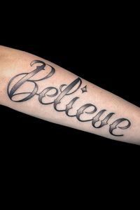 Black and grey script of "Believe"