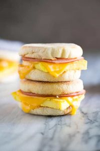 Freezer Breakfast Sandwiches made with baked eggs and topped with cheese, sausage, bacon, or ham on an English muffin. These make ahead sandwiches are easy and delicious. #makeahead #freezerbreakfastsandwich #sausage #ham #englishmuffin #bacon #breakfast #easy #best