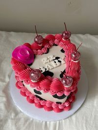 fun cow cake, pink vintage piping with black cow spots, glitter cherries, “22 BABY” with fondant cutout letters, pink glitter cowboy hat