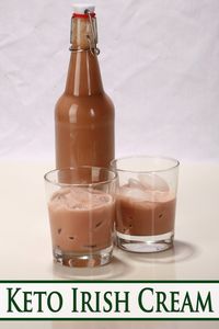 A bottle of keto Irish cream behind 2 short glasses of sugar-free irish cream on ice.