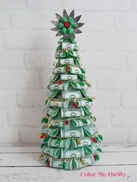 When I was young I loved board games, and Monopoly was one of my favorites. This upcycled monopoly money Christmas tree is a great way to create something that’s full of childhood memories, but it’s also fun and funky.For more upcycled and repurposed projects check out my blog, Color Me Thrifty, here. Lately I’ve been finding Monopoly games at thrift stores for a dollar or two. A few weeks ago I shared these rosette ornaments made with different denominations of Monopoly money. For t…