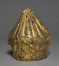 11-12 c. Syria. Cap ("Qalansuva"). It consists of silk sewn to a heavily quilted form, the top part of which is ribbed. The design of the silk is based on an eight-pointed star with paired birds above and stylized palmettes in the interspaces. Such hats were worn with or without a turban by persons of rank. lampas weave, silk, Overall - h:22.00 w:20.00 d:20.00 cm (h:8 5/8 w:7 13/16 d:7 13/16 inches). Acc. # 1950.525