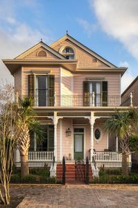 Experience the captivating charm of a New Orleans pink Victorian home. Tour this exquisite residence with its own carriage house.