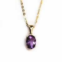 Oval amethyst gemstone set in solid 14K gold prong setting. The amethyst stone is 7mm x 5mm and is the birthstone for the month of February. Amethyst gemstones are found mainly in Brazil. Chain is optional. Image is enlarged for better view.